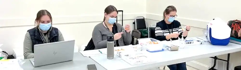 Members of the RCDHU team working with COVID-19 vaccines